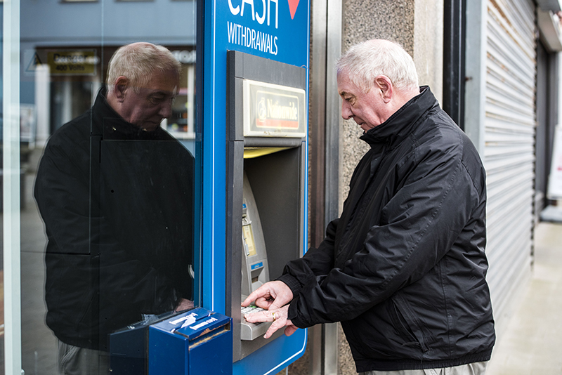 Man using an ATM cash point