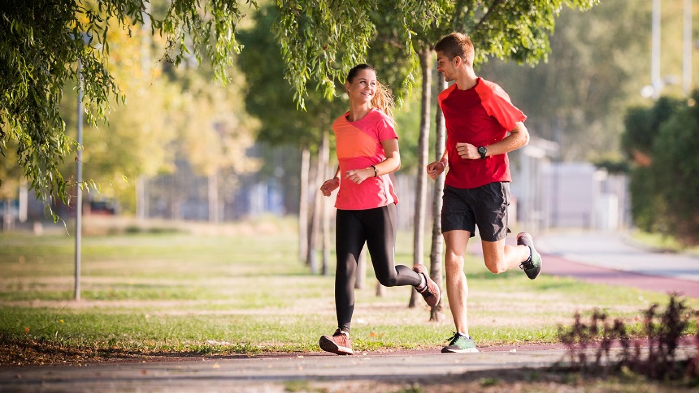 Couple running in a park.