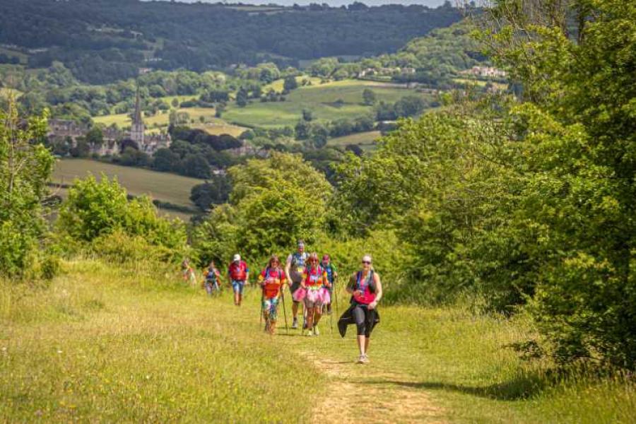 A group trekking through the Cotswolds