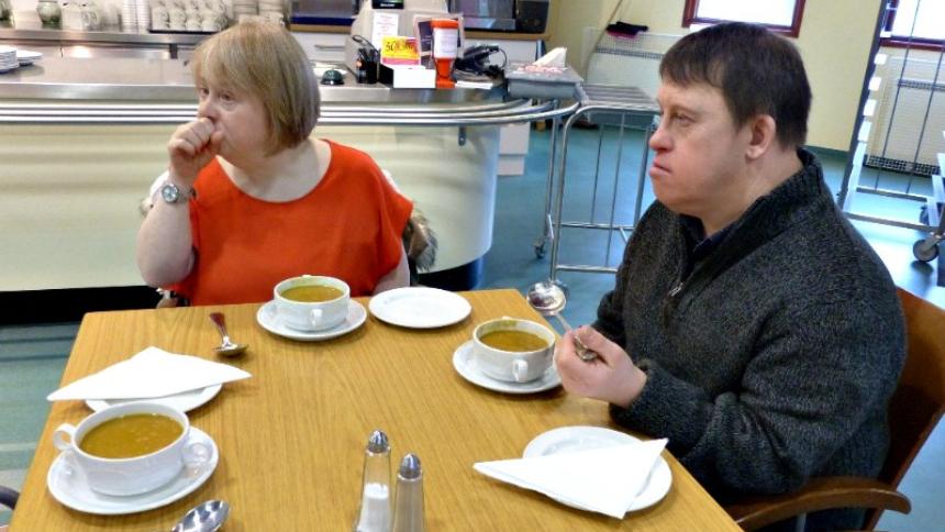 Couple with Down's syndrome at a cafe