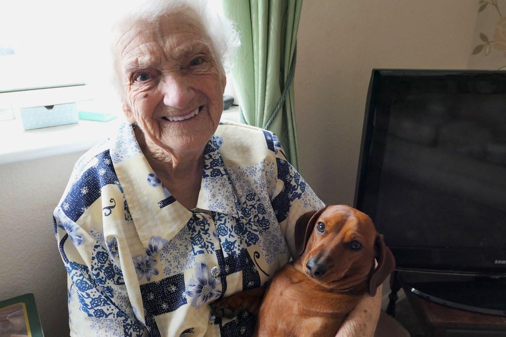 Winifred loves holding Orla the dementia-friendly dog like a baby