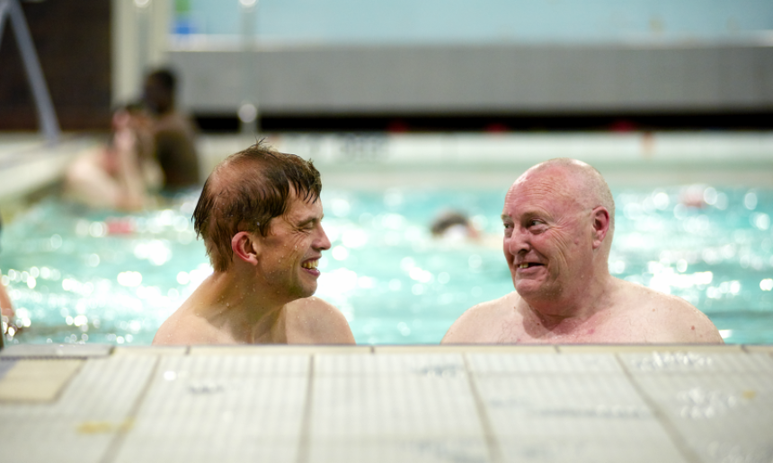 A Dementia Friend swimming with a person living with dementia