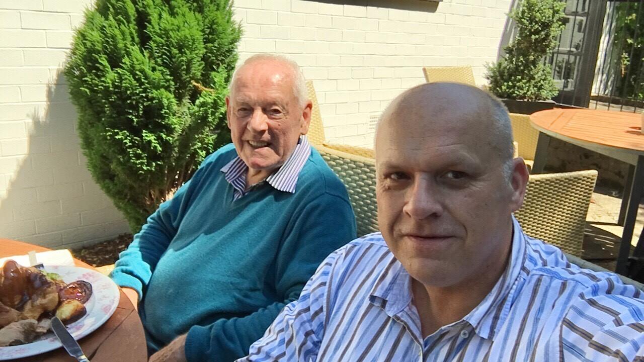 Andy and his dad enjoying the sun